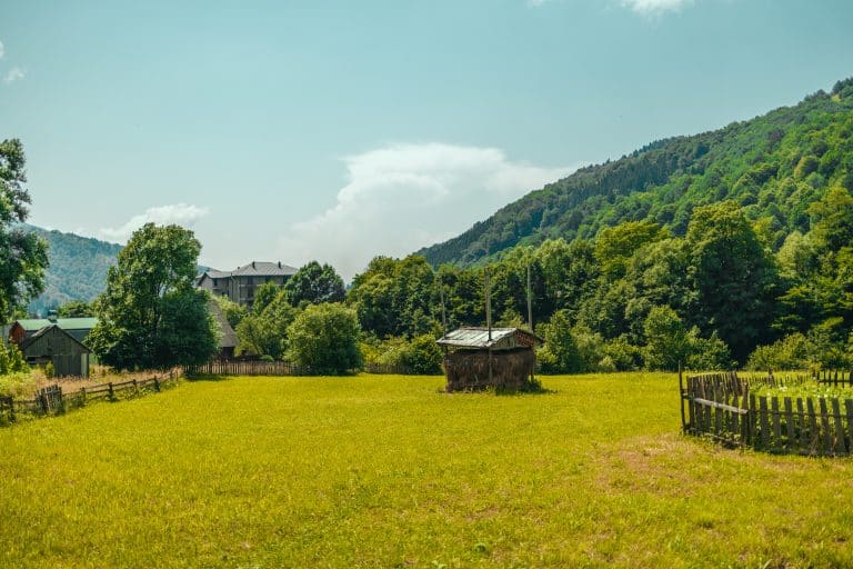 Village with a haystack high in the mountains in summer Sunlight, clouds